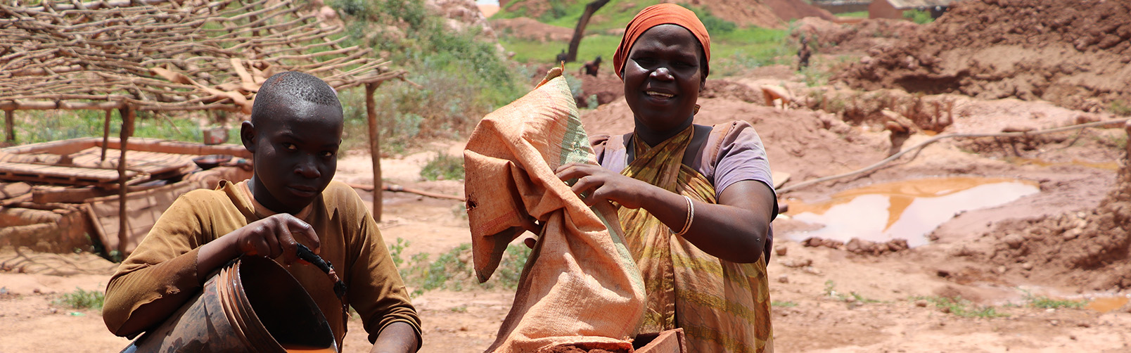 woman and boy with sack and bucket, Africa