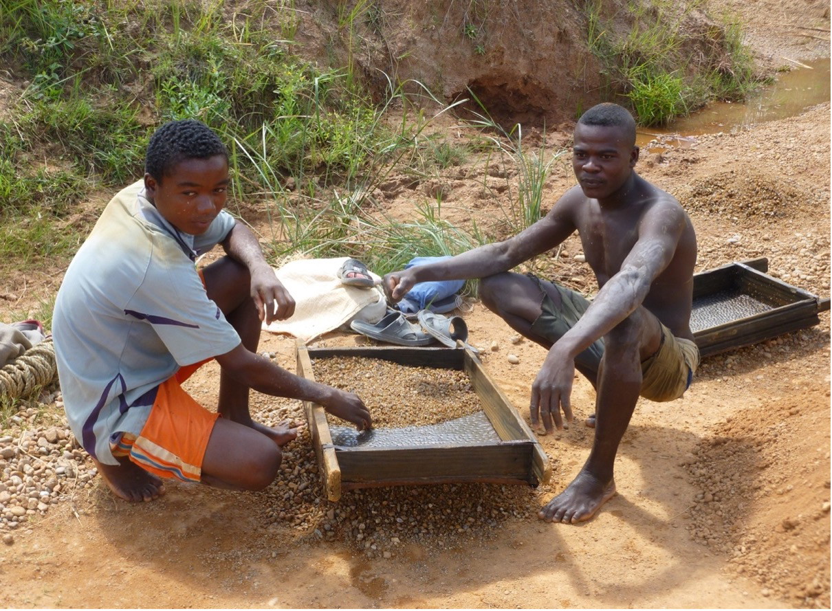 Sieving gravels to reveal and pick coloured gemstones from an alluvial deposit. (Photo courtesy of Swarovski.)