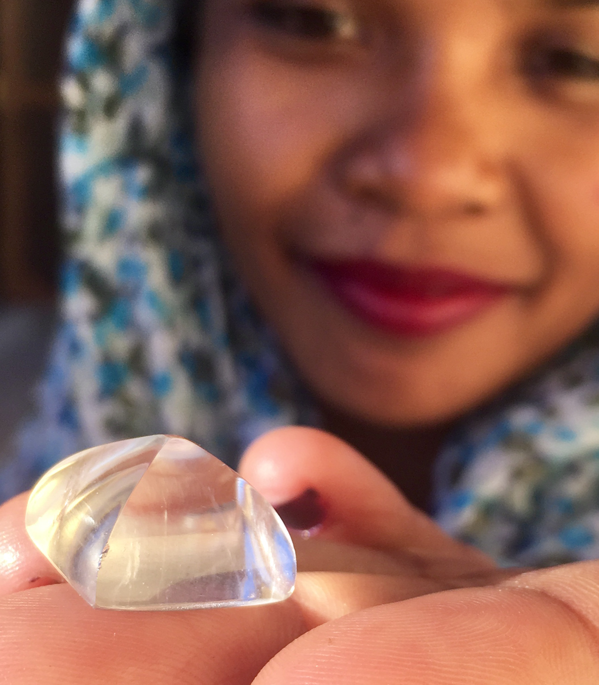 Lapidary Razafiasimbola Hanita, a lapidary in Madagascar, holds a quartz “sugarloaf”. Image: Lynda Lawson